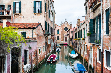 Fototapeta na wymiar Scenic canal with old architecture in Venice, Italy. Famous travel destination