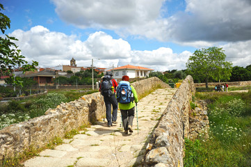 Pilgrims in the roman bridge over the Ayuela river, province of Caceres, Spain. Here cross the Via...