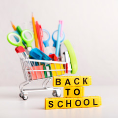 Back to school text with office supplies in shopping truck