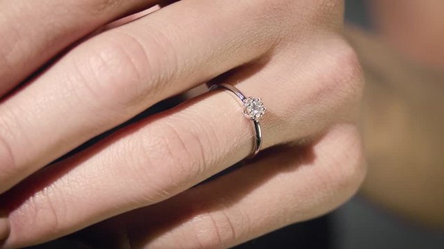 Close-up view of woman's hand with engagement diamond ring