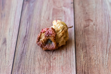 Rotten spoiled apple fruit, stub. D Damaged products, mold. Copy space for your text. Still life with fruit.