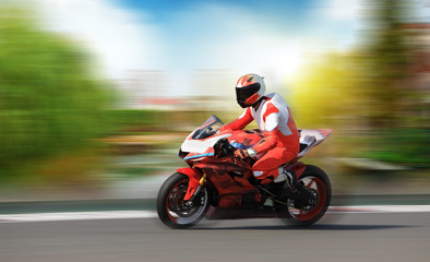 Fototapeta na wymiar Racing bike rider racing at high speed on a colorful background