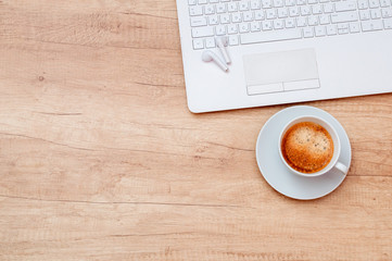 Coffee, laptop and headphones on wooden table. Relax concept