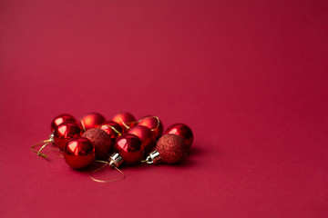 Red Christmas tree decorative toy balls on red celebratory Christmas background. New Year's holidays. Christmas holidays