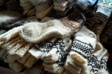 Fototapeta na wymiar knitted socks of machine knitting from natural wool of different sizes for sale on the shelves