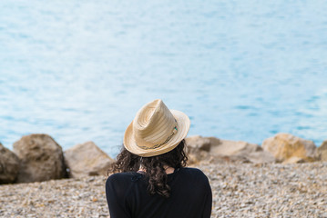 girl in hat enjoys sea view. rest 