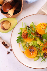 fresh avocado and orange salad on a beige plate