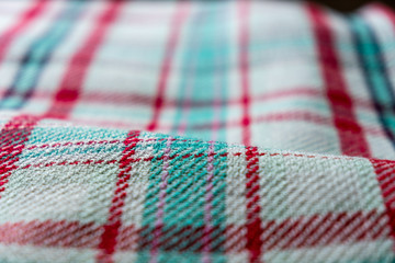 Shallow Depth of Field Closeup of a Checkered, Plaid, Traditional, European-Style of Blanket Made out of Cotton