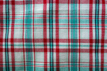 Flat Lay of a Checkered, Plaid Blanket Fabric Pattern with White, Red and Turquoise Green/ Blue Colours Laid Out