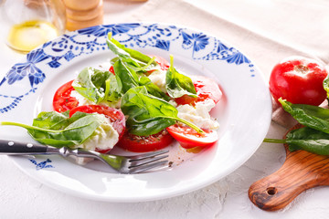 fresh tomato, cheese and spinach salad. Summer salad