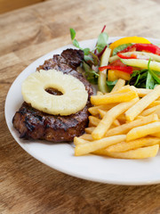 Hawaiian Pineapple Steak served with potato chips and salad.