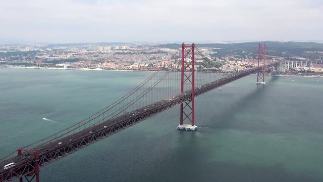 Aerial panorama view over the 25 de Abril Bridge. The bridge is connecting the city of Lisbon to the municipality of Almada on the left bank of the Tejo river, Lisbon