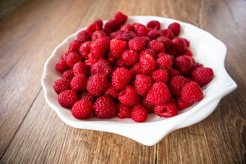 Fresh raw organic raspberries on a plate