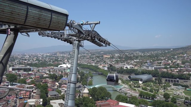 Cableway with cable car over the most famous Narikala Fortress and Peace bridge. Tbilisi, Georgia.