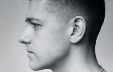 Profile portrait of young serious caucasian man