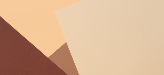 Color papers geometry composition banner background with beige, light brown and dark brown tones.