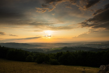 Landscape view on meadow with blue sky with many clouds and forest close to city Valasske Mezirici captured during summer late time.