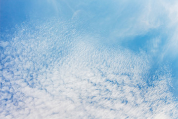 Blue sky with small white clouds, background for design_