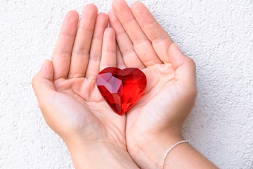 woman hands holds red heart