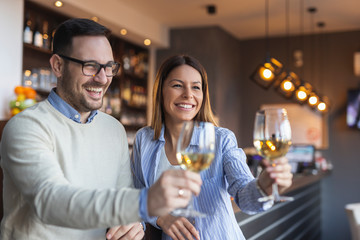 Couple raising glasses and making a toast