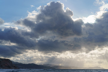 Sun beams over the Atlantic ocean after the rain.