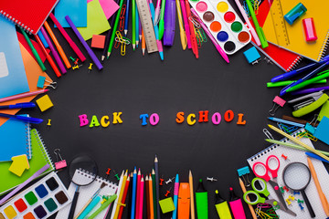 Different office Supplies On black background with text