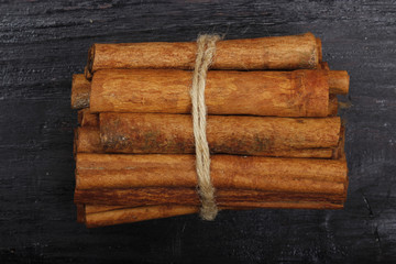 heap of stickes of cassia isolated on black background