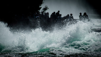 Tourists at the roaring waters of the Rhine Falls near Schaffhausen.