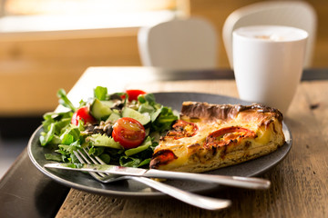 Slice of courgette tart with a salad on a plate. Concept for cafe, restaurant, lunch