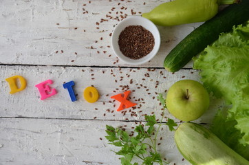 Word detox is made from colored letters. chia seeds. Green smoothies and ingredients. Concept of diet, cleansing the body, healthy eating. lemon green apple, greens, lettuce, vegetables