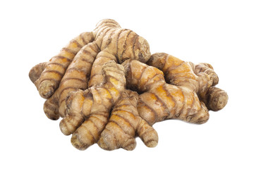 heap of turmeric roots isolated on white background