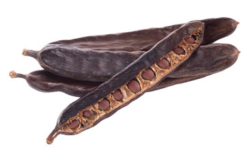 Obraz premium heap of carob pods isoalted on white background