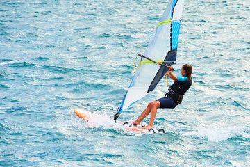  Water sports on Lake Garda in Torbole resort. Windsurfer Surfing The Wind On Waves, Recreational Water Sports, Selective focus
