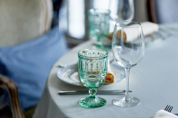 Classic table setting at the Banquet. Glasses of light green glass. wedding Banquet.