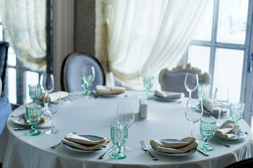 Classic table setting at the Banquet. Glasses of light green glass. wedding Banquet.