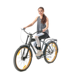 Fototapeta na wymiar Sporty young woman riding bicycle against white background
