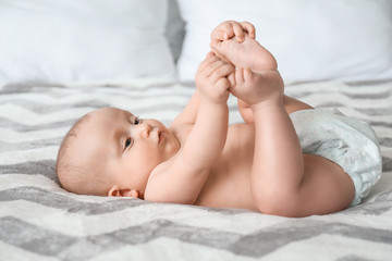 Adorable little baby lying on bed