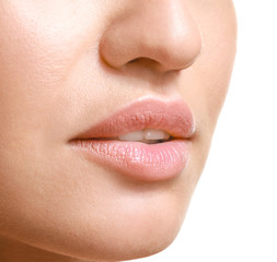Fototapeta premium Young woman with beautiful lips on white background, closeup