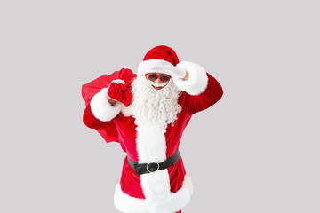 Portrait of cool Santa Claus on light background