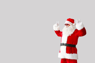 Portrait of cool Santa Claus on light background