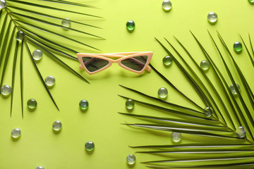 Composition with stylish sunglasses on color background