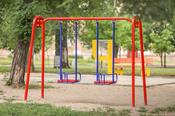 Swings on playground in park