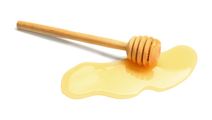 Wooden honey dipper on white background