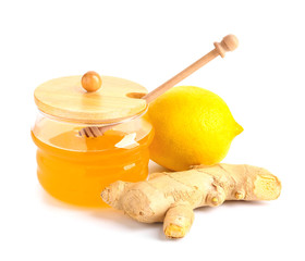 Jar of fresh honey, lemon and ginger on white background