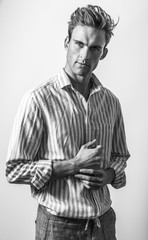 Elegant young handsome man in classic shirt. Black-white portrait.