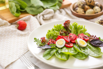 Plate with fresh tasty salad on table
