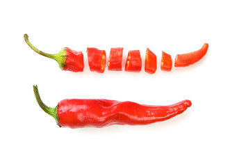Whole and cut red chili peppers on white background