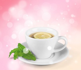 Tea with sliced lemon on background