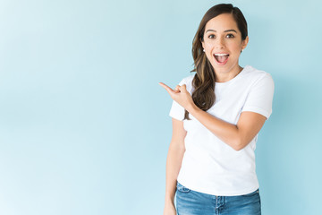 Attractive Female Gesturing Over Plain Background