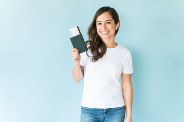 Smiling Woman Holding Passport In Studio